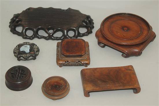 Six Oriental carved wood stands and a cover.